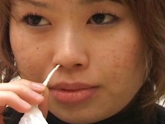 Japanese daughter blows will not hear of nose onto a bunch of Kleenex tissues